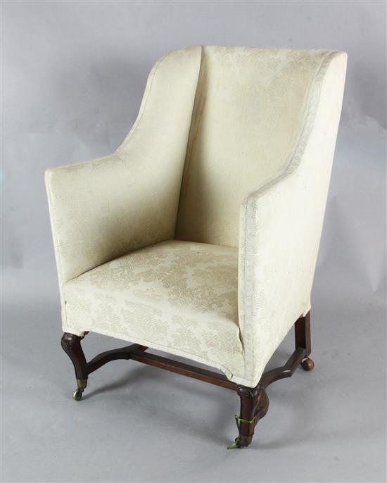 An early 19th century mahogany wing armchair